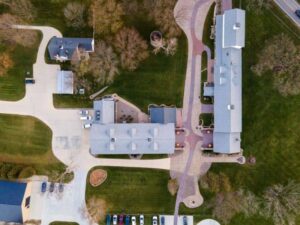 Aerial view of residential properties, buildings, and driveways showing existing conditions for a subdivision survey